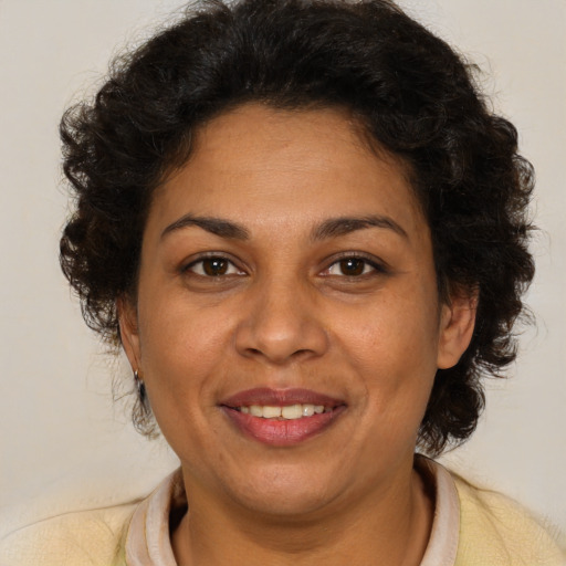 Joyful white adult female with medium  brown hair and brown eyes