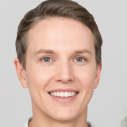 Joyful white adult male with short  brown hair and grey eyes