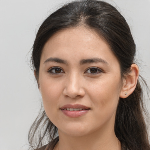 Joyful white young-adult female with long  brown hair and brown eyes