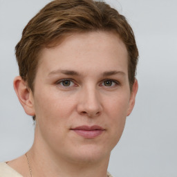 Joyful white young-adult female with short  brown hair and grey eyes