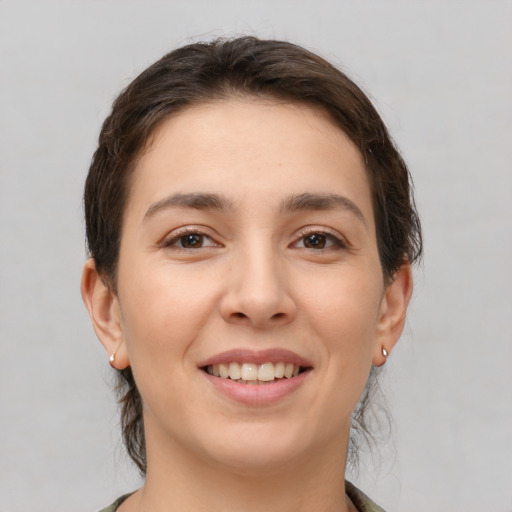 Joyful white young-adult female with medium  brown hair and brown eyes