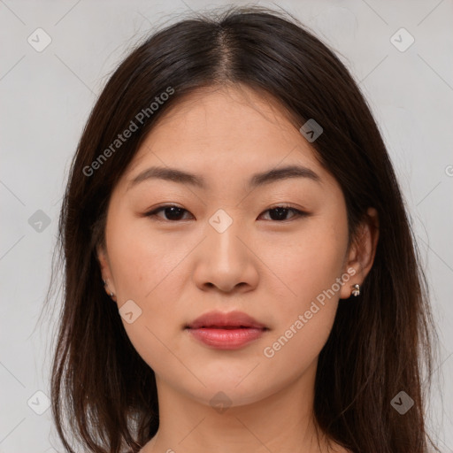 Joyful asian young-adult female with long  brown hair and brown eyes