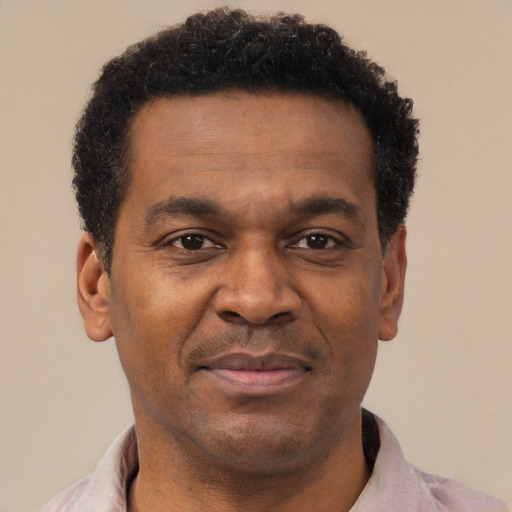 Joyful latino adult male with short  brown hair and brown eyes