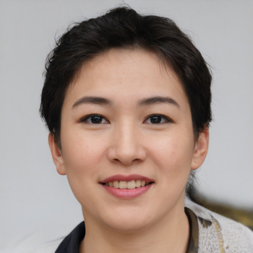 Joyful asian young-adult female with short  brown hair and brown eyes