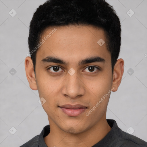 Joyful latino young-adult male with short  brown hair and brown eyes