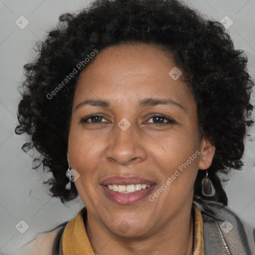 Joyful black adult female with medium  brown hair and brown eyes