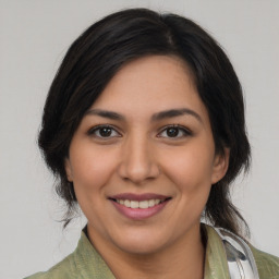 Joyful latino young-adult female with medium  brown hair and brown eyes