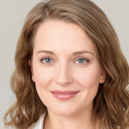 Joyful white young-adult female with medium  brown hair and green eyes