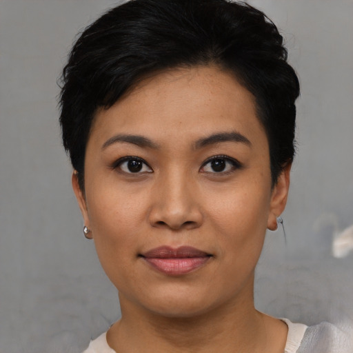 Joyful asian young-adult female with short  black hair and brown eyes