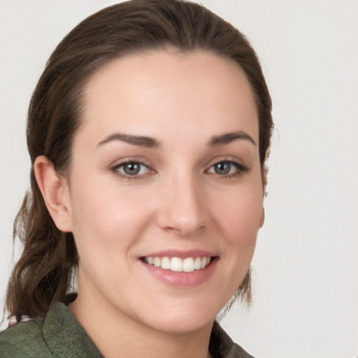 Joyful white young-adult female with medium  brown hair and grey eyes