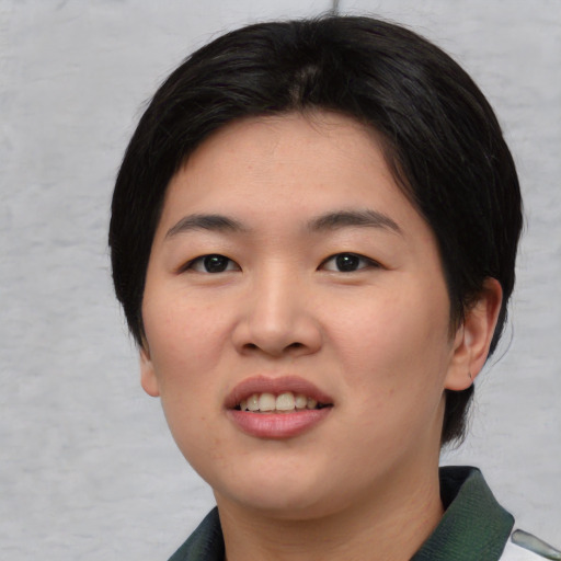 Joyful asian young-adult female with medium  black hair and brown eyes