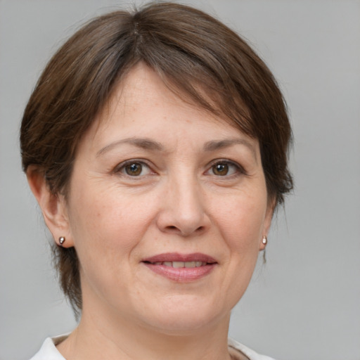 Joyful white adult female with medium  brown hair and brown eyes