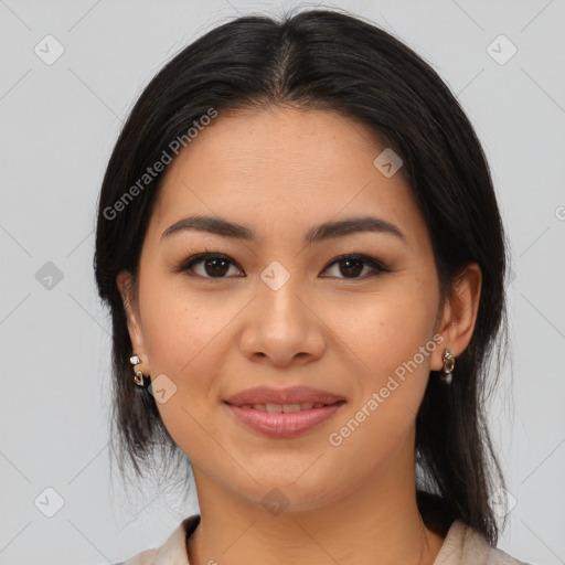 Joyful latino young-adult female with medium  brown hair and brown eyes