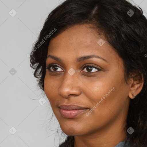 Joyful black young-adult female with long  brown hair and brown eyes