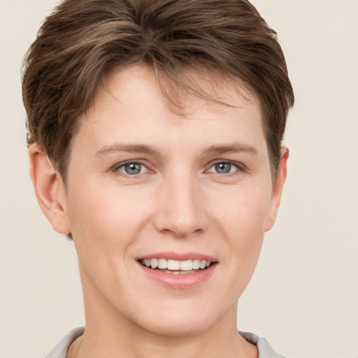 Joyful white young-adult female with short  brown hair and grey eyes