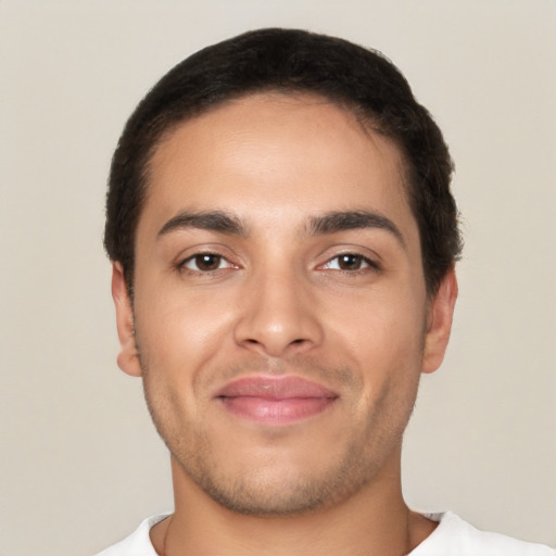 Joyful latino young-adult male with short  brown hair and brown eyes