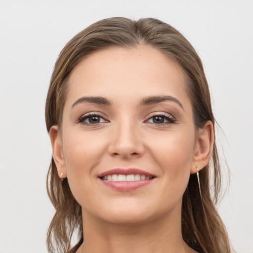 Joyful white young-adult female with long  brown hair and grey eyes