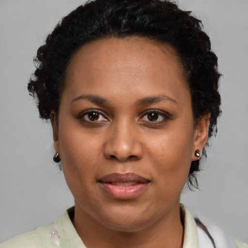 Joyful black adult female with short  brown hair and brown eyes