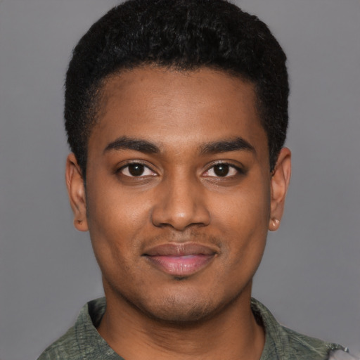 Joyful black young-adult male with short  black hair and brown eyes