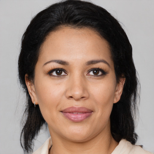 Joyful latino young-adult female with medium  brown hair and brown eyes