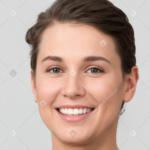 Joyful white young-adult female with short  brown hair and grey eyes