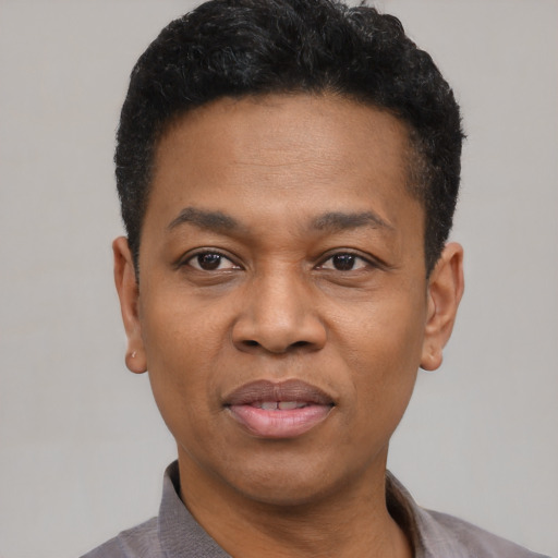 Joyful black adult male with short  black hair and brown eyes
