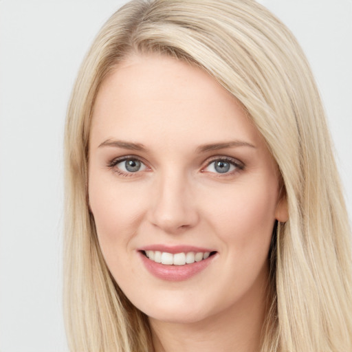 Joyful white young-adult female with long  brown hair and blue eyes