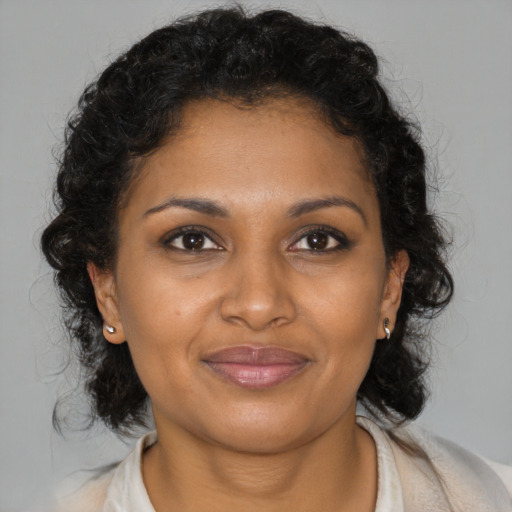 Joyful black young-adult female with medium  brown hair and brown eyes