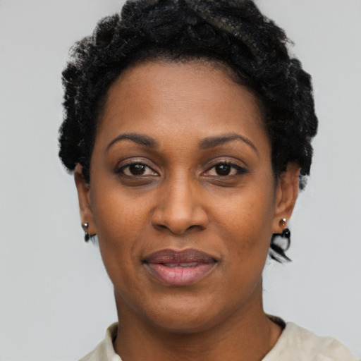 Joyful black adult female with short  black hair and brown eyes