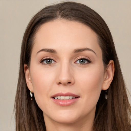 Joyful white young-adult female with long  brown hair and grey eyes