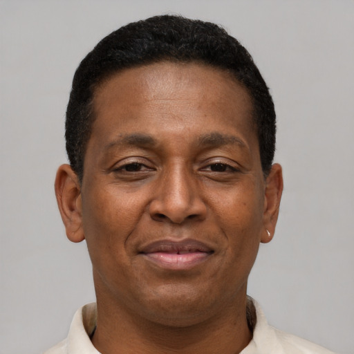 Joyful latino adult male with short  brown hair and brown eyes