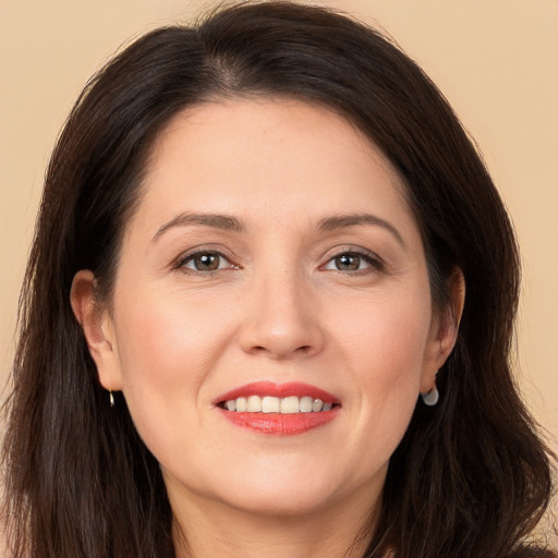 Joyful white young-adult female with long  brown hair and brown eyes