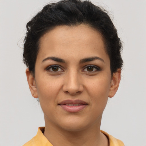 Joyful latino young-adult female with short  brown hair and brown eyes