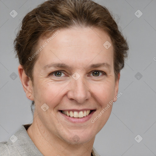 Joyful white adult female with short  brown hair and grey eyes