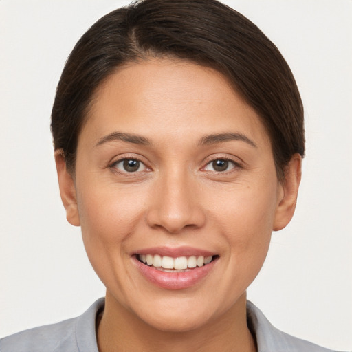 Joyful white young-adult female with short  brown hair and brown eyes