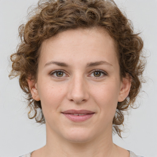 Joyful white young-adult female with medium  brown hair and green eyes