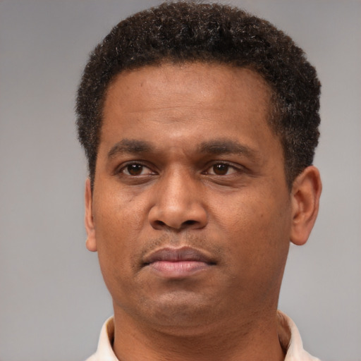 Neutral latino adult male with short  brown hair and brown eyes