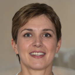 Joyful white adult female with short  brown hair and brown eyes