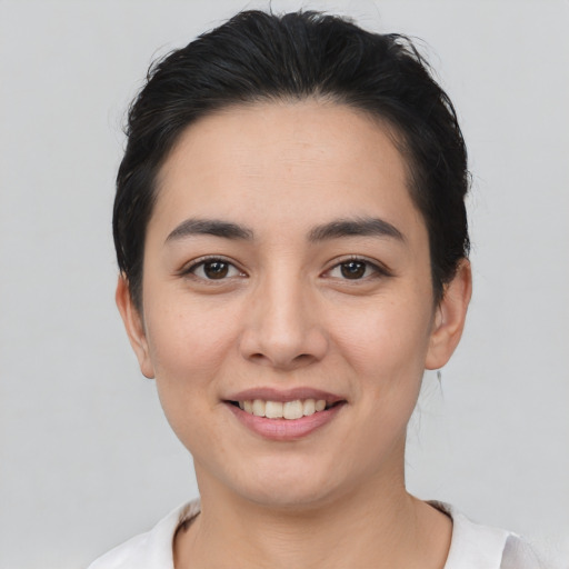 Joyful asian young-adult female with short  black hair and brown eyes