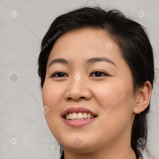 Joyful asian young-adult female with medium  brown hair and brown eyes