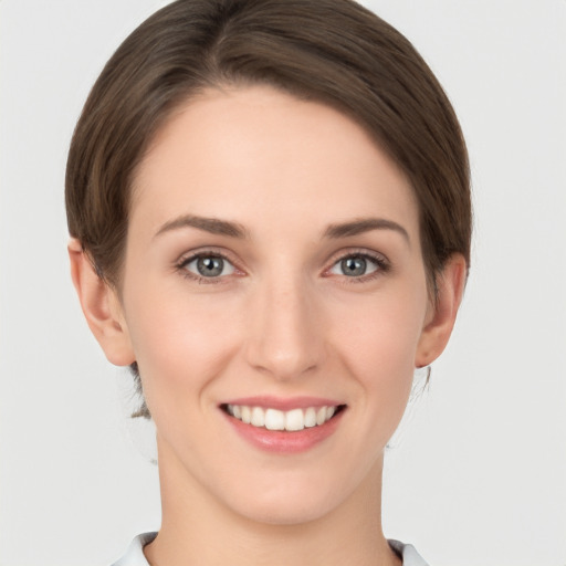 Joyful white young-adult female with short  brown hair and grey eyes