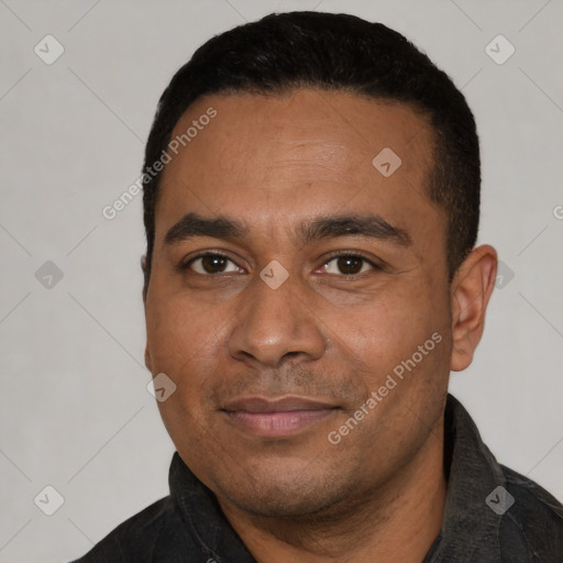 Joyful latino young-adult male with short  black hair and brown eyes