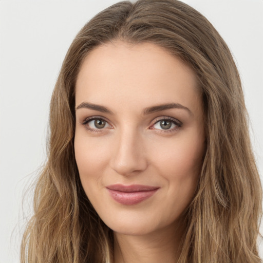 Joyful white young-adult female with long  brown hair and green eyes