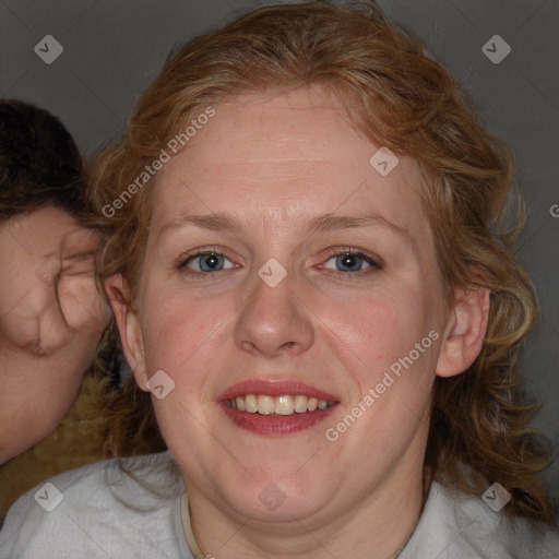 Joyful white adult female with medium  brown hair and blue eyes