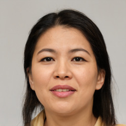 Joyful asian adult female with medium  brown hair and brown eyes