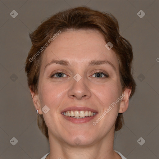 Joyful white adult female with short  brown hair and grey eyes