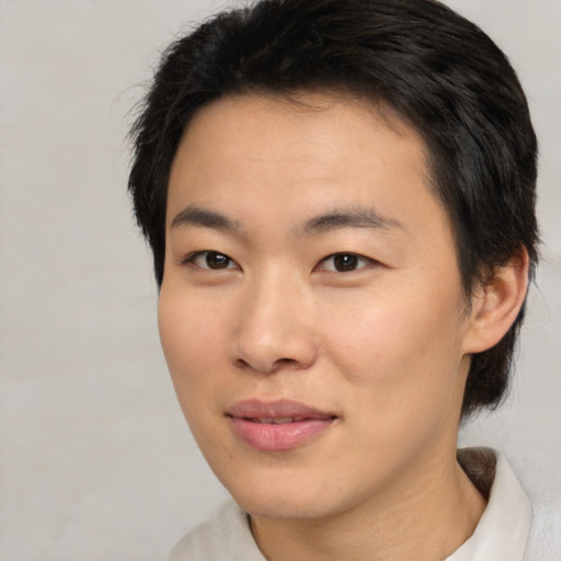 Joyful asian young-adult male with short  brown hair and brown eyes