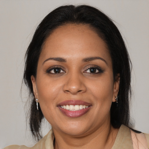 Joyful black young-adult female with medium  brown hair and brown eyes