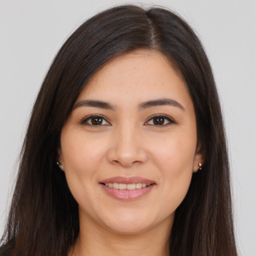 Joyful white young-adult female with long  brown hair and brown eyes
