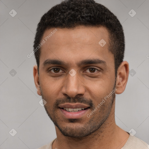 Joyful black young-adult male with short  black hair and brown eyes